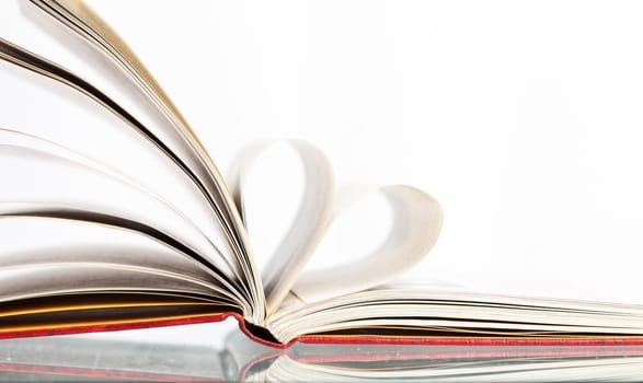 Close up on heart shaped book pages