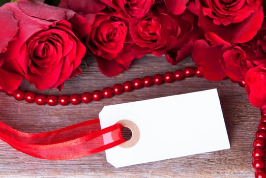 A White Empty Label with Red Roses as Background