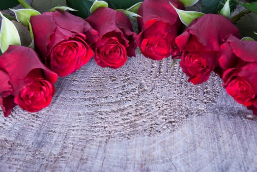 A Wooden Background with Red Roses and Copyspace