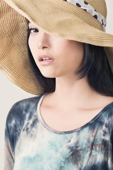 Glamour of Asian beauty with hat, closeup portrait.