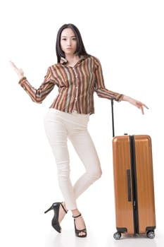 Modern Asian woman stand with a luggage, full length portrait on white background.