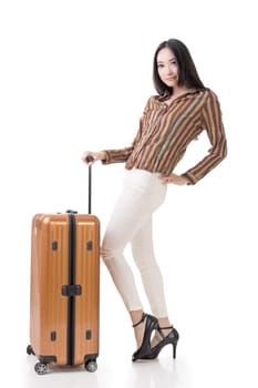 Modern Asian woman stand with a luggage, full length portrait on white background.