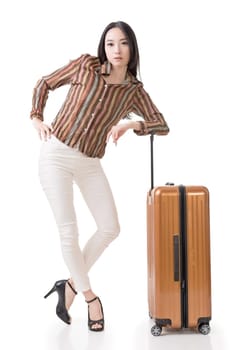 Modern Asian woman stand with a luggage, full length portrait on white background.