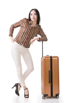 Modern Asian woman stand with a luggage, full length portrait on white background.