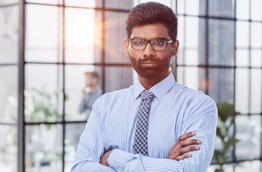 male investor beard looking at camera and smiling in modern office