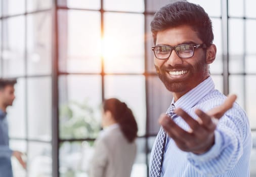 male investor beard looking at camera and smiling in modern office