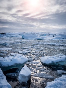 A group of icebergs floating on top of a body of water. Photo of a stunning view of icebergs floating in the crystal-clear waters of Iceland