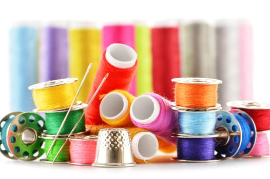 Composition with tailor needles and threads over white background