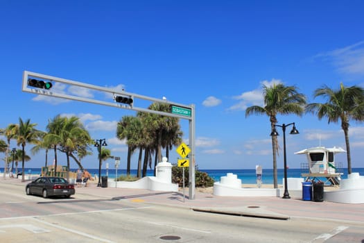 FORT LAUDERDALE, FLORIDA - MARCH 3, 2013: View from across the street of the opening to Sebastian beach at the end of Sebastian Street where it intersects with State Road A1A on a sunny day in winter.