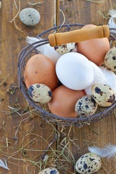 Vintage wire basket with various raw eggs for Easter