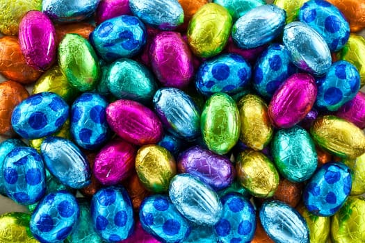 Colorful chocolate eggs as a background for Easter