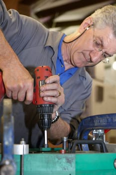 senior worker cleaning his hands with a cloth