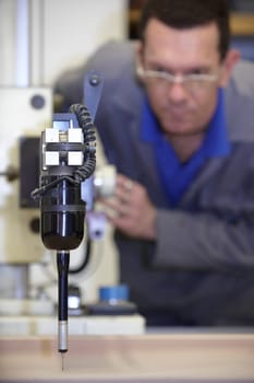 worker using a multisensor touch probe to inspect measurements