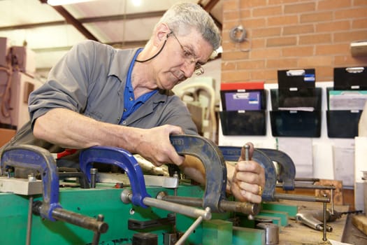 senior worker cleaning his hands with a cloth