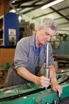 senior worker cleaning his hands with a cloth