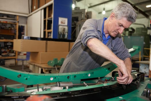 senior worker on factory floor in the manufacturing industry