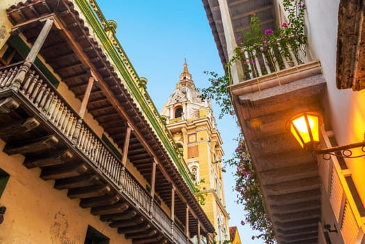 View looking up at historic colonial balconies and a church in Cartagena, Colombia