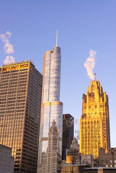 View of several skyscrapers in Chicago with the golden light of an early morning sunrise