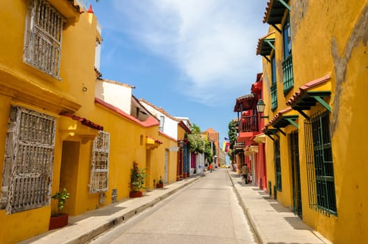 Typical street scene in Cartagena, Colombia of a street with old historic colonial houses on each side of it