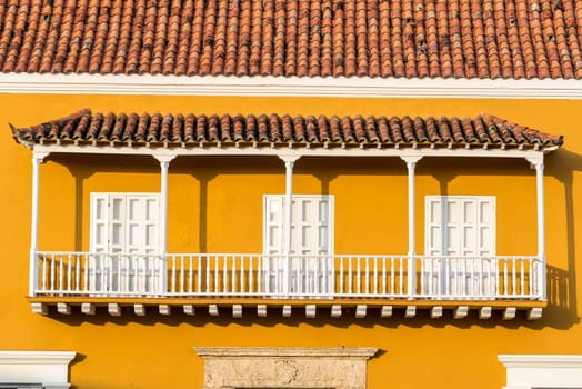 Historic yellow and white colonial balcony in the center of Cartagena, Colombia