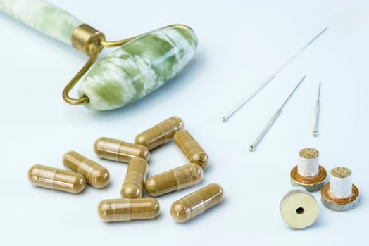 Acupuncture needles with moxa cones and herbal pills