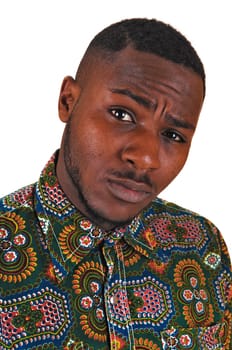 A portrait picture of a black young man standing for white background .looking worrisome into the camera..