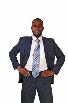 A young black business man standing in a suit and tie, with his hands.on his hips for white background..