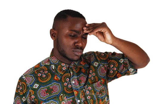 A handsome young black man in a colorful shirt with hand on his.forehead, for white background..