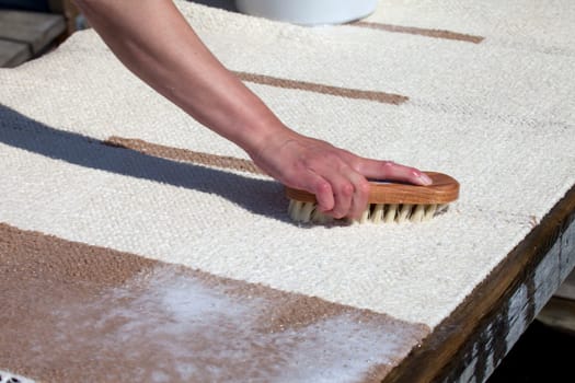 Scrubbing carpet on the dock