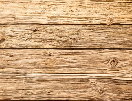 Rustic background of very rough textured weathered wooden planks with knots in a horizontal parallel pattern