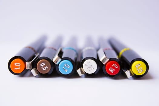 Technical pens on a white background.