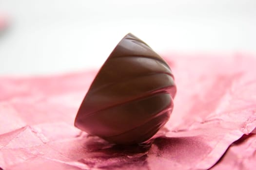 Chocolate candy on a pink wrapping.