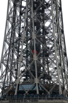 Paris,France – December 29,2013: Tourists stand on the lowest platform of the Eiffel Tower and wait for the elevator on December 29,2013 in Paris.
