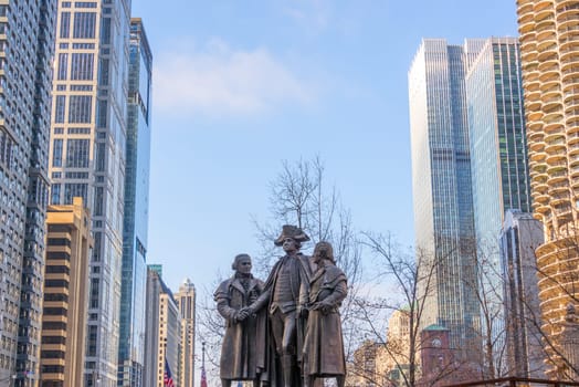Public statue of George Washington with skyscrapers on either side in downtown Chicago