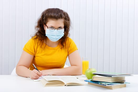 young female student in a medical face mask