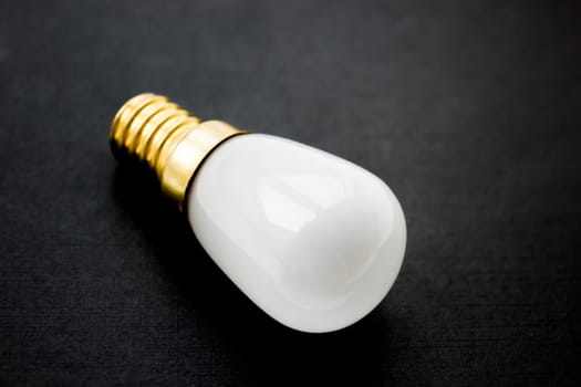 Light bulb on a black background.