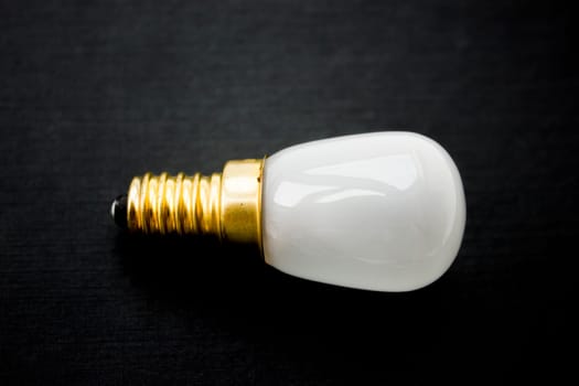 Light bulb on a black background.