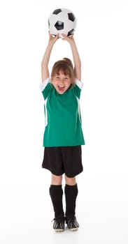Full length front view of young girl holding soccer ball. White background.