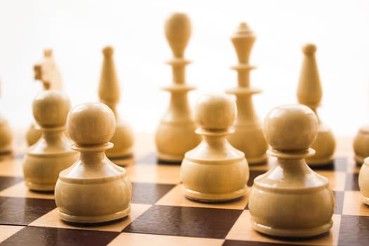 Chess pieces on a board in different compositions.