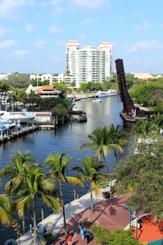 FORT LAUDERDALE, FLORIDA - MARCH 23, 2013: High above view of Riverwalk Park and New River waterway in downtown with people walking on the brick sidewalk on a pleasant winter day.