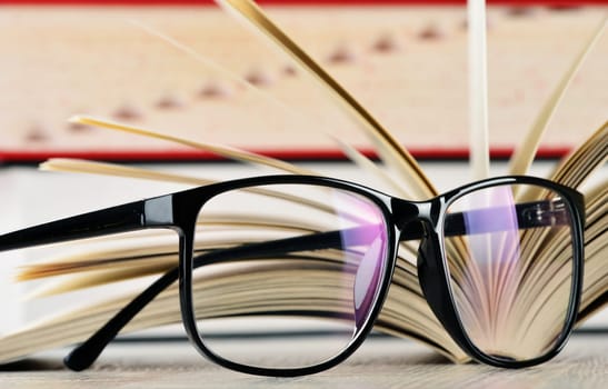 Composition with glasses and books on the table