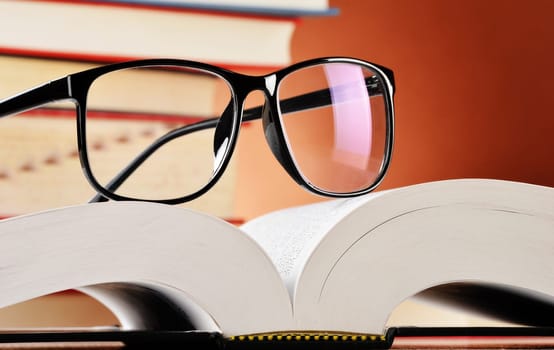 Composition with glasses and books on the table