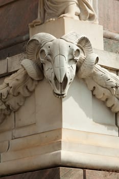Ram's head at the base of the obelisk in front of St. Nicholas Church