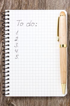 Pen and notepad with a to-do list