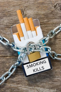 Pack of cigarettes and a padlock with chain