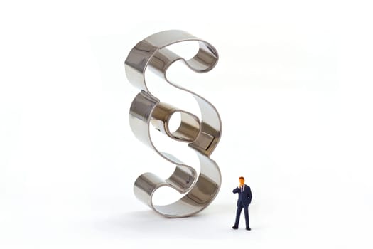 Miniature figure with paragraph characters on a light background