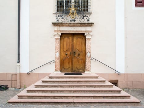 frontal view of a portal with stairs and ancient double-wing door in Merano / South Tyrol in the Tappeiner Weg  Summer 2013