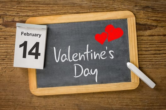 Calendar and blackboard showing February 14, Valentine's day