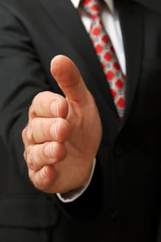 closeup of businessman's hand outstretched for a handshake
