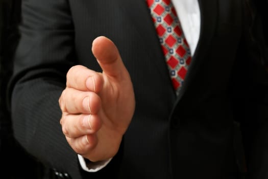 closeup of businessman's hand outstretched for a handshake